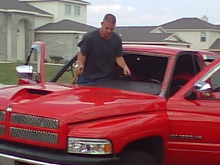 Windshield replacement on a red pickup truck